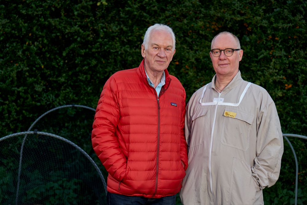 Two older friends standing together outdoors